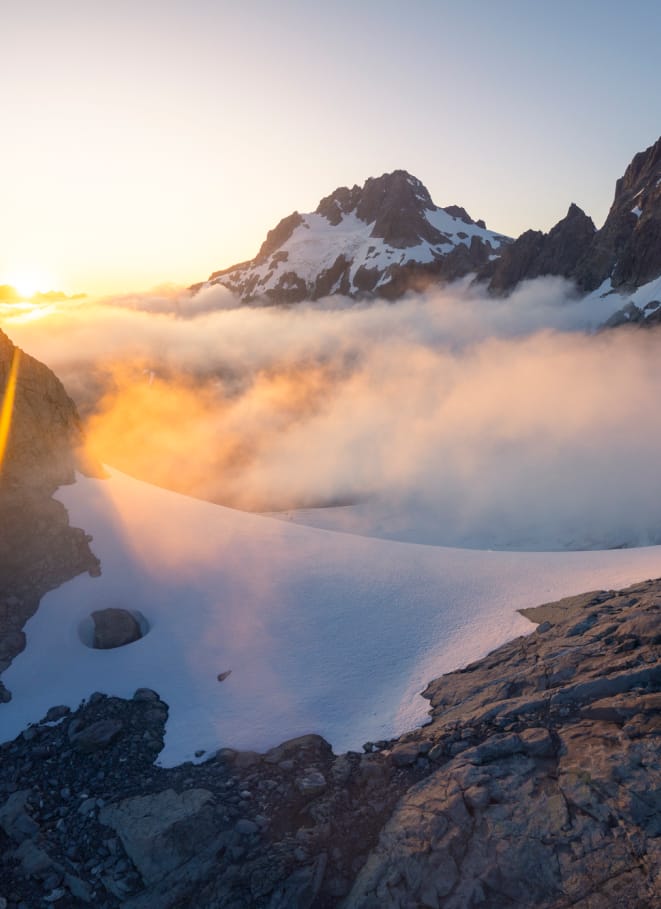 Looking out above the clouds at mountain peaks